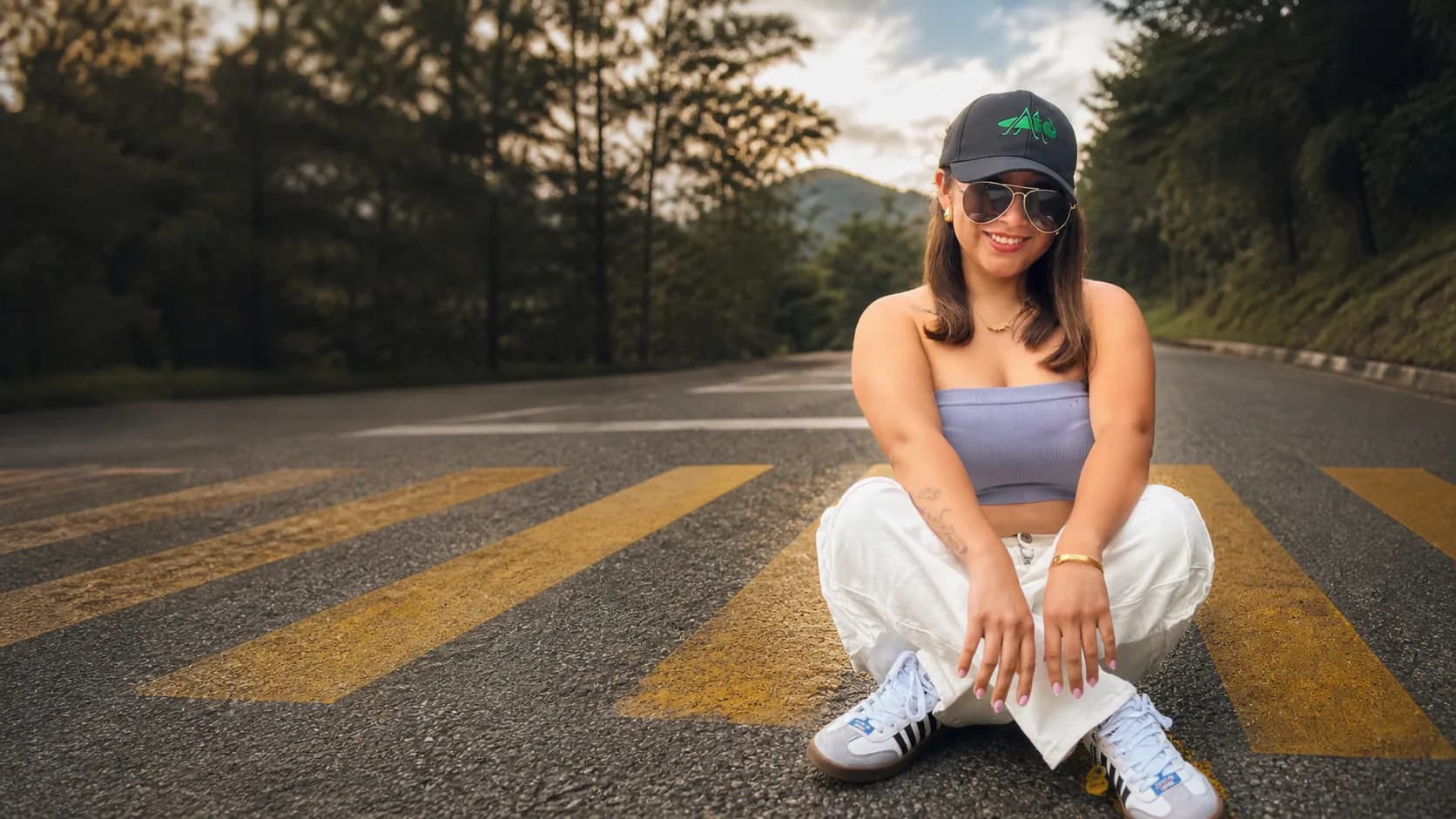 Modelo usando una gorra TerraCaps en una carretera entre montañas